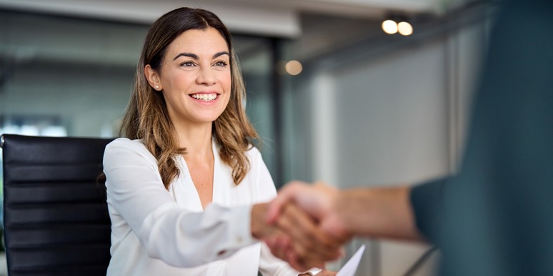 A job applicant and employer shaking hands after a successful interview