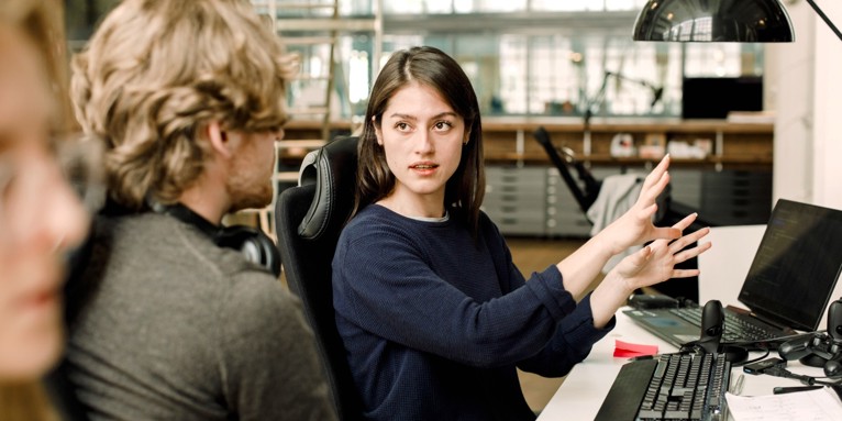 Two colleagues discussing a project at work